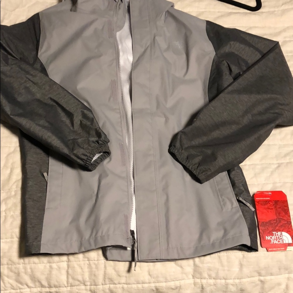 Girls large north face rain jacket. NEVER WORN